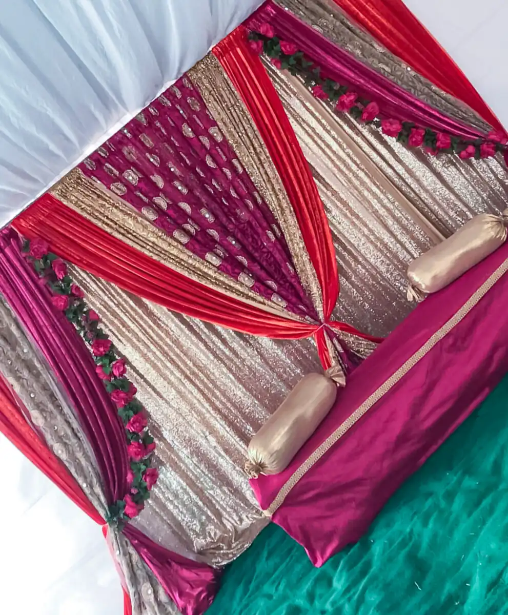 Magenta and gold mehndi seating backdrop · Dream Decorators