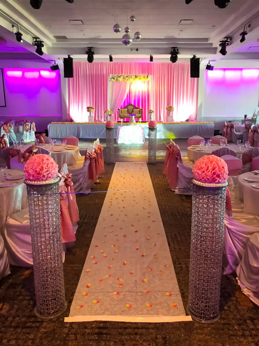 Pink reception hall with crystal aisle pillars · Dream Decorators Surrey