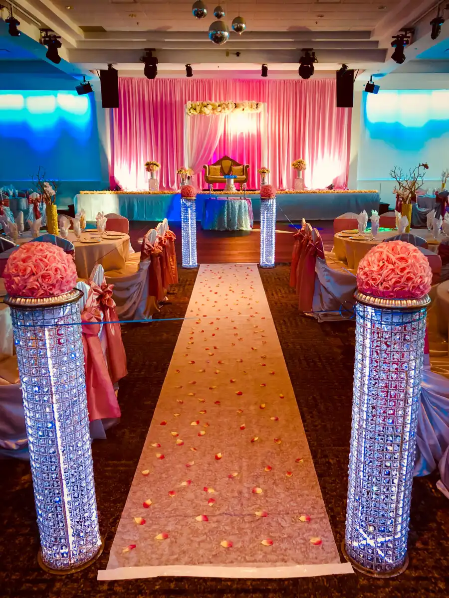 Pink and gold ballroom aisle with crystal pillars · Dream Decorators Surrey