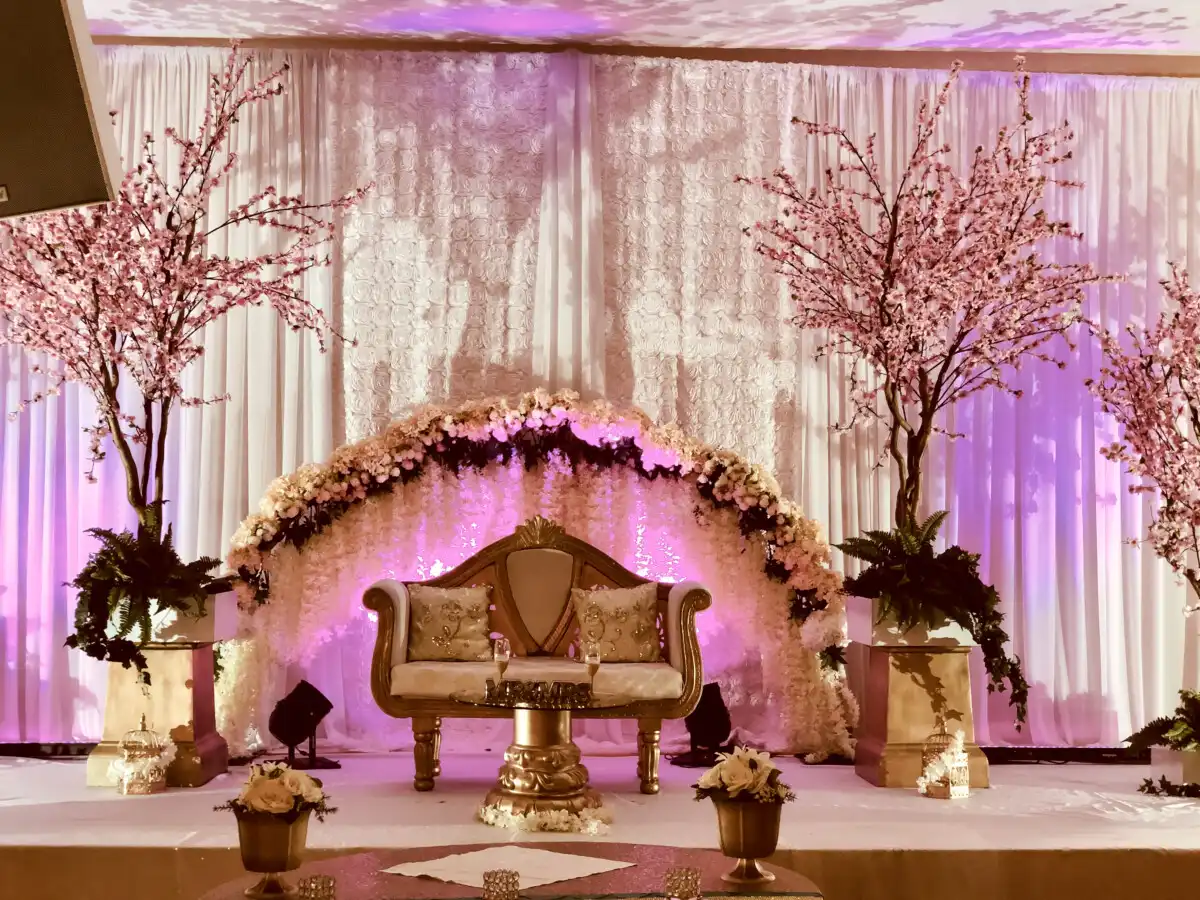 Cherry blossom floral arch reception stage · Dream Decorators