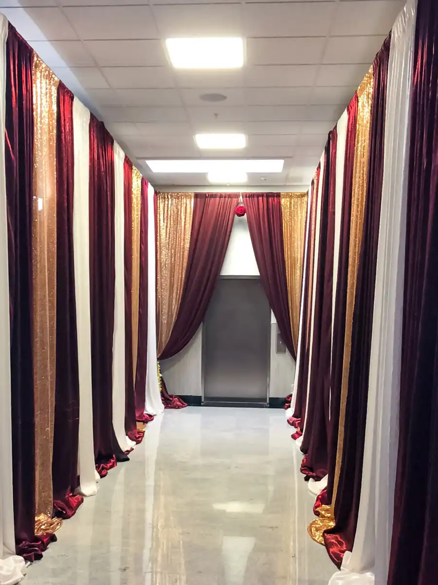Burgundy and gold hallway entrance draping · Dream Decorators Surrey