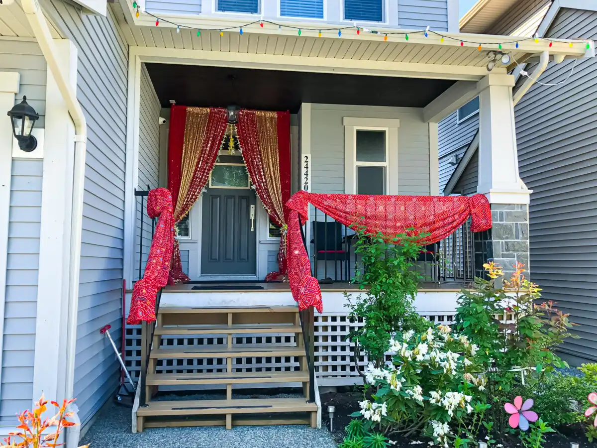 Red and gold home porch entrance with bandhani fabric · Dream Decorators Surrey
