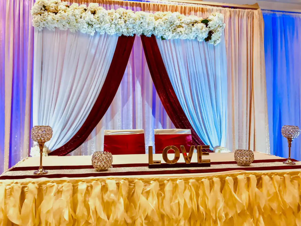 Burgundy and gold LOVE sweetheart table · Dream Decorators