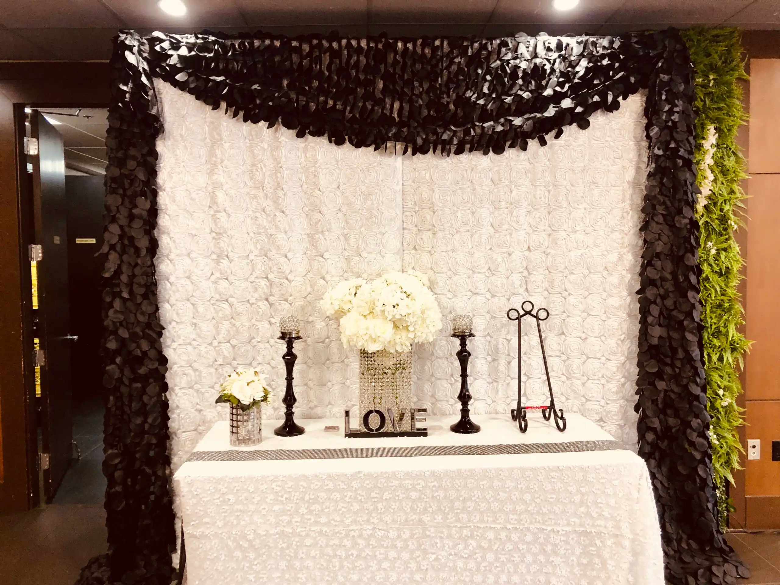 Black and white rosette reception welcome table · Dream Decorators