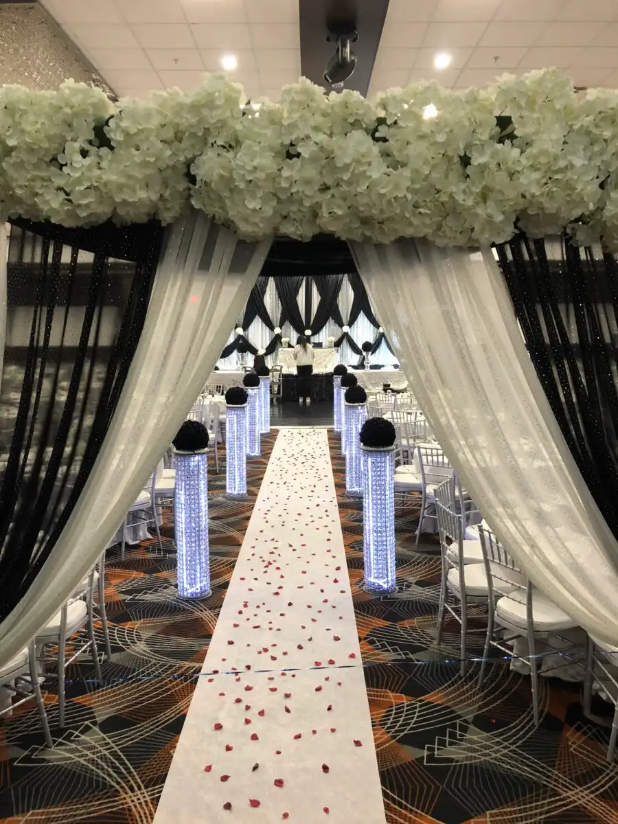 Black and white floral reception aisle entrance · Dream Decorators
