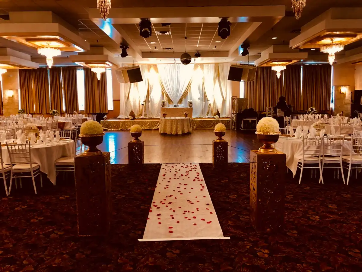 White and gold ballroom wedding reception setup · Dream Decorators