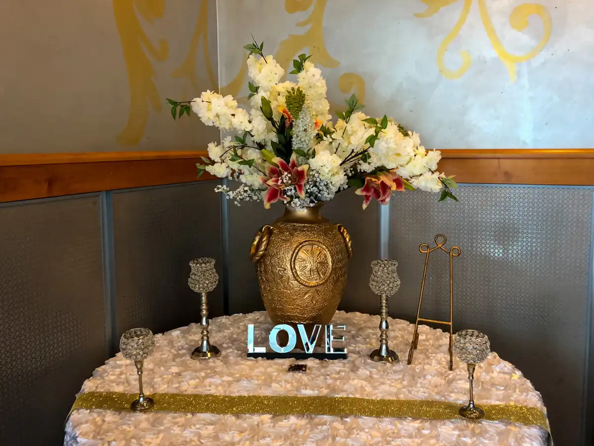 Gold floral welcome table with LOVE sign · Dream Decorators