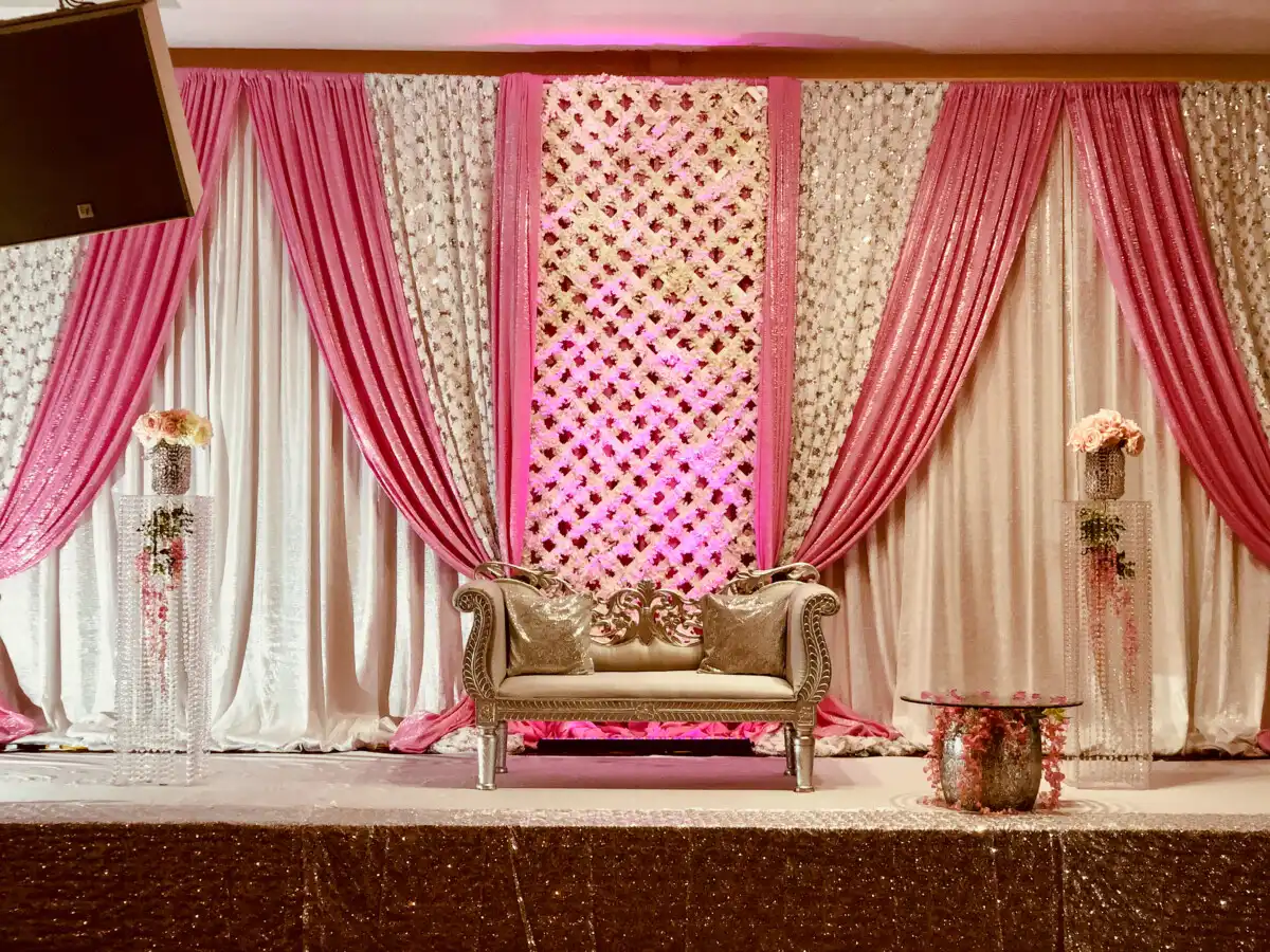 Pink floral lattice and silver reception stage · Dream Decorators