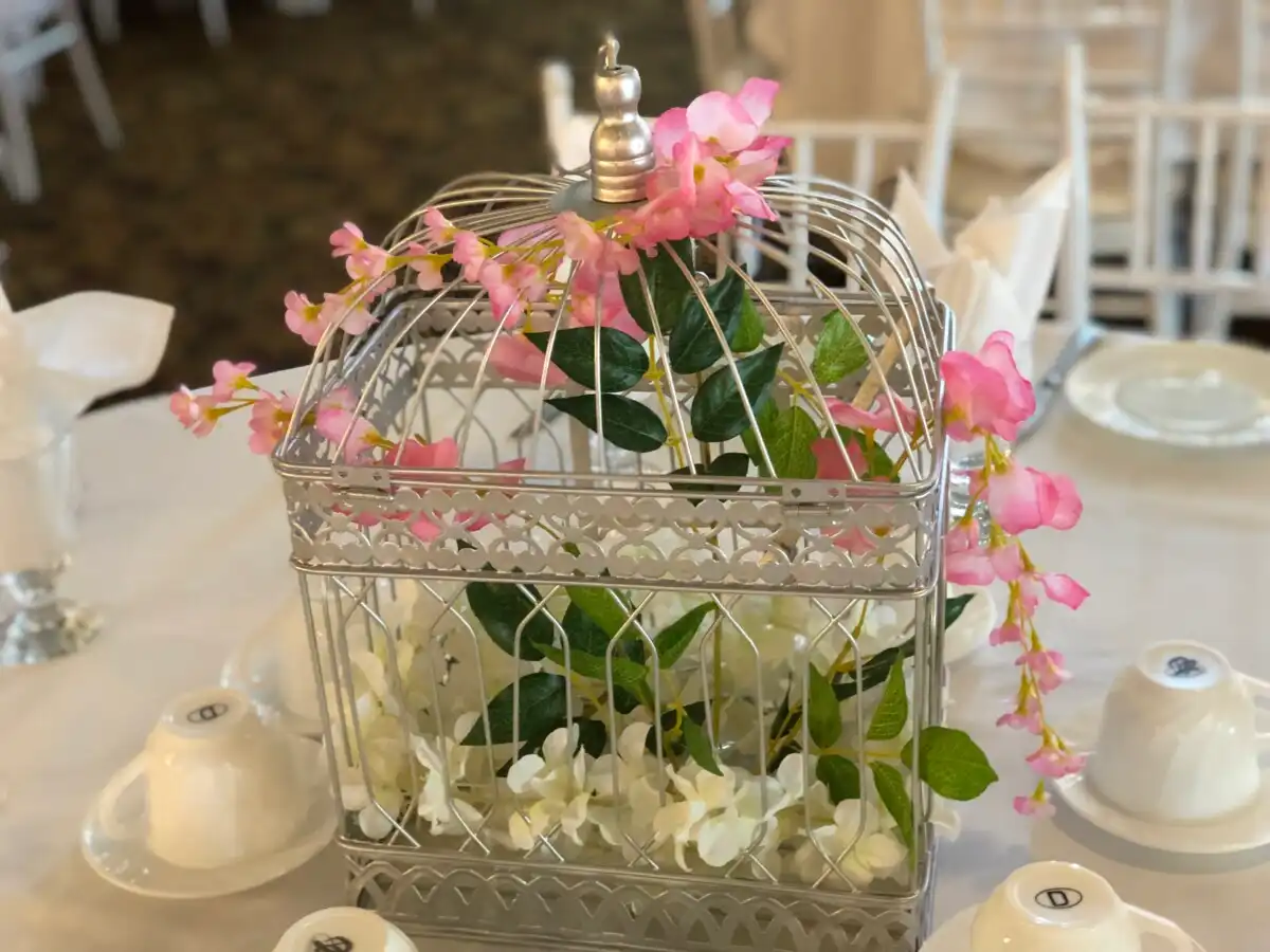 Silver birdcage centerpiece with pink cherry blossoms · Dream Decorators