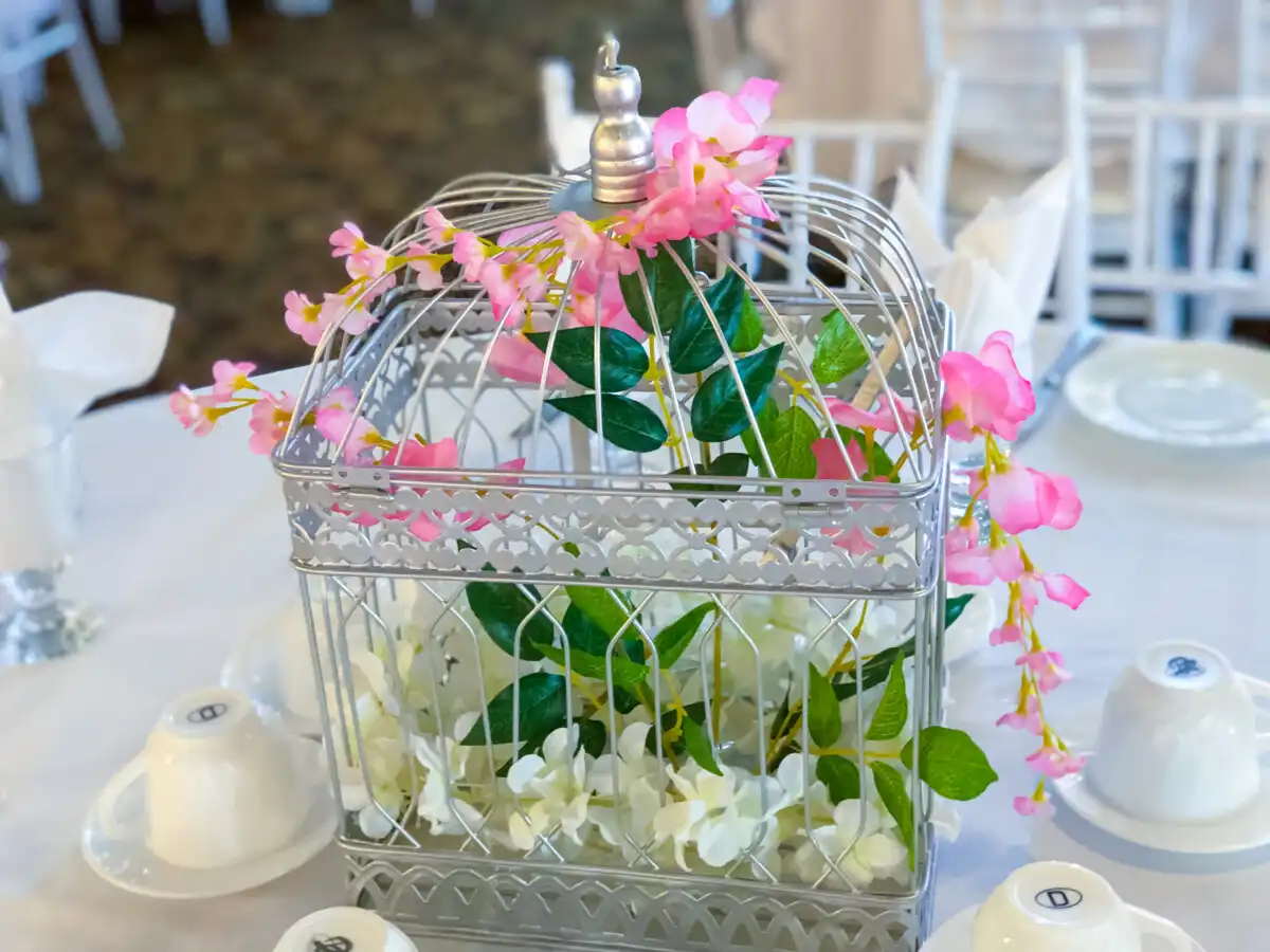 Silver birdcage floral wedding centerpiece · Dream Decorators