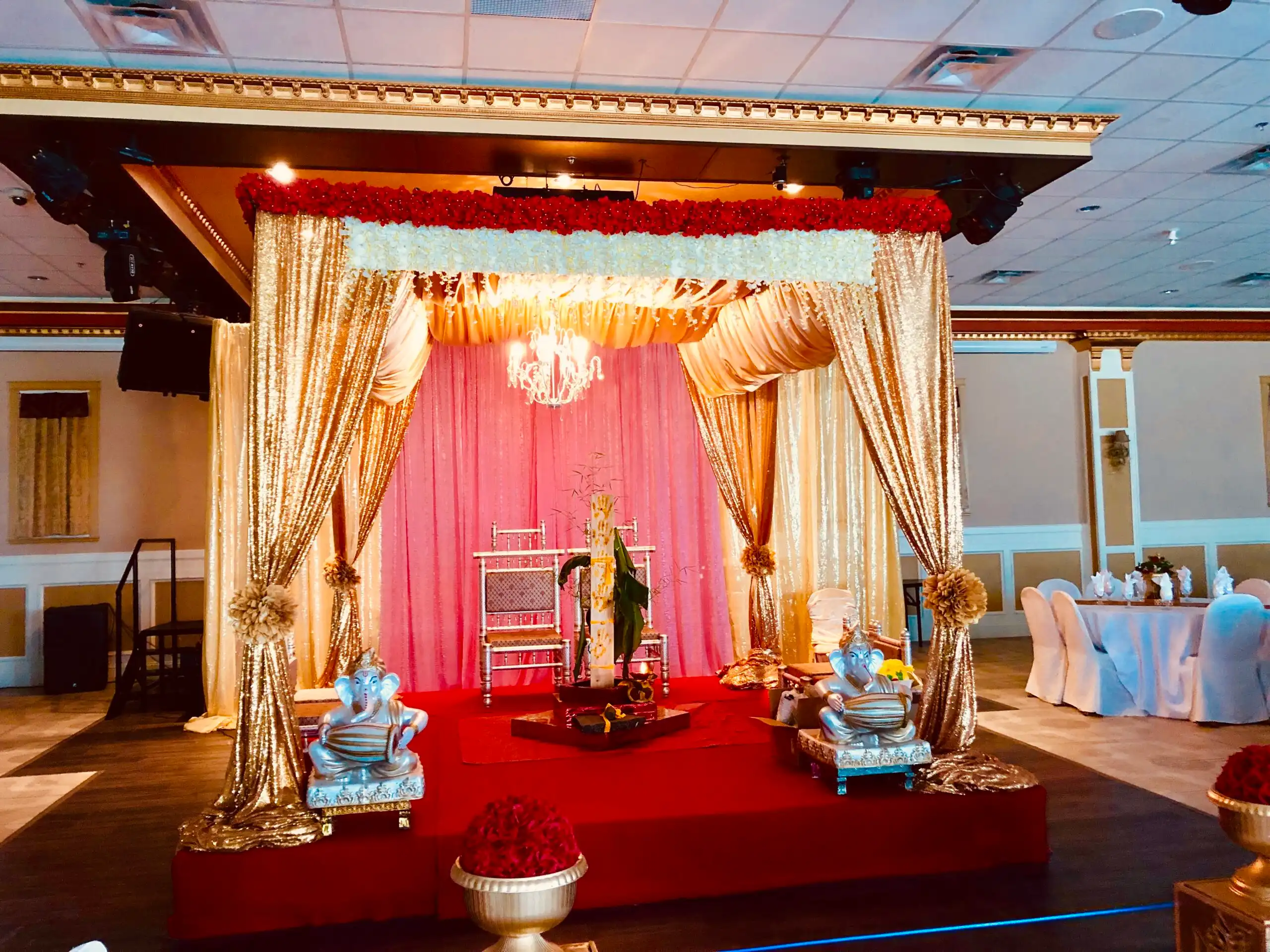 Gold sequin Hindu mandap with Ganesha idols · Dream Decorators