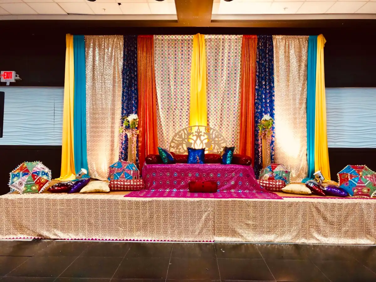 Vibrant sangeet stage with Rajasthani umbrellas · Dream Decorators