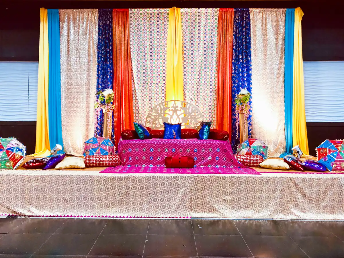 Multi-coloured mehndi diwan stage décor · Dream Decorators