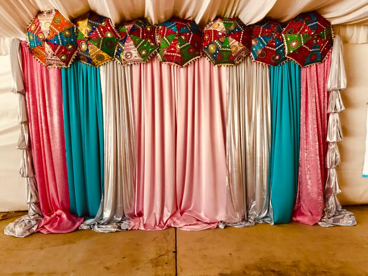 Pink and teal backdrop with embroidered chhatris · Dream Decorators