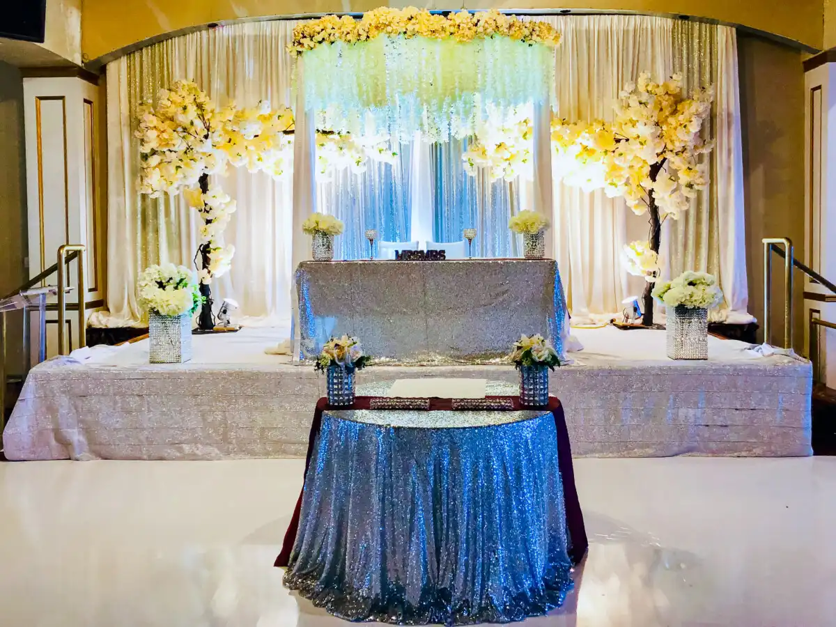 Silver sequin reception stage with floral canopy · Dream Decorators