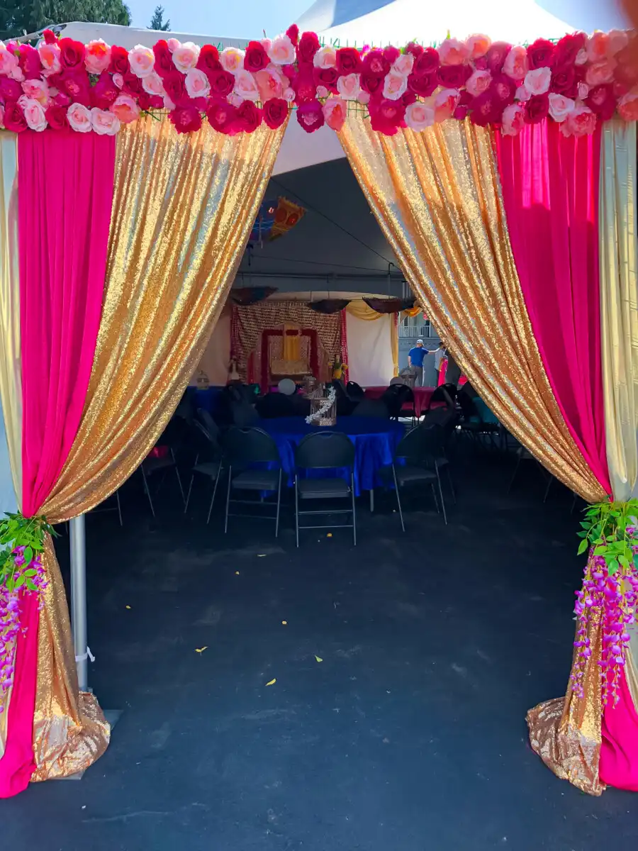 Pink and gold outdoor tent entrance décor · Dream Decorators Surrey