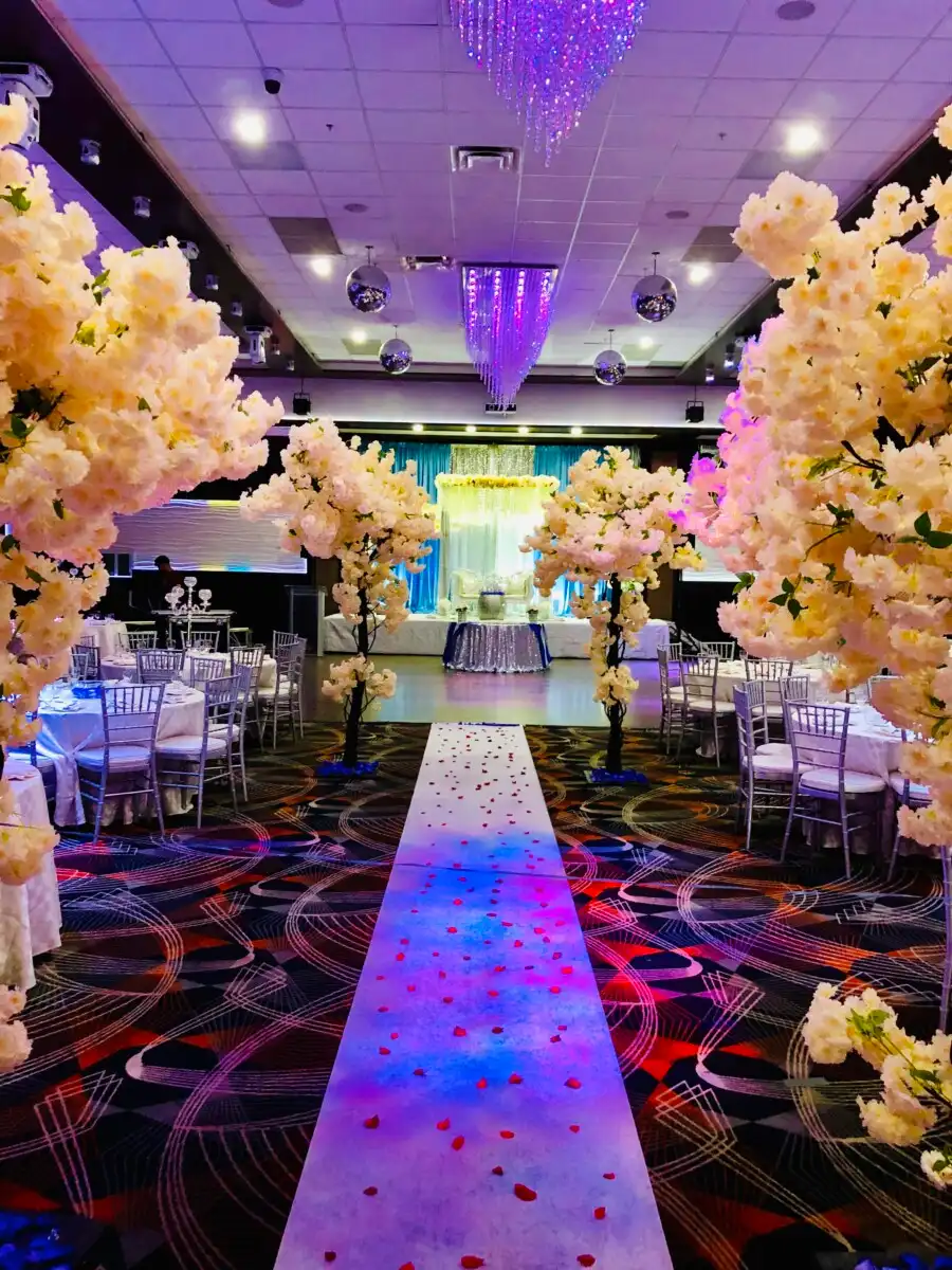 Cherry blossom reception aisle with blue lighting · Dream Decorators Surrey