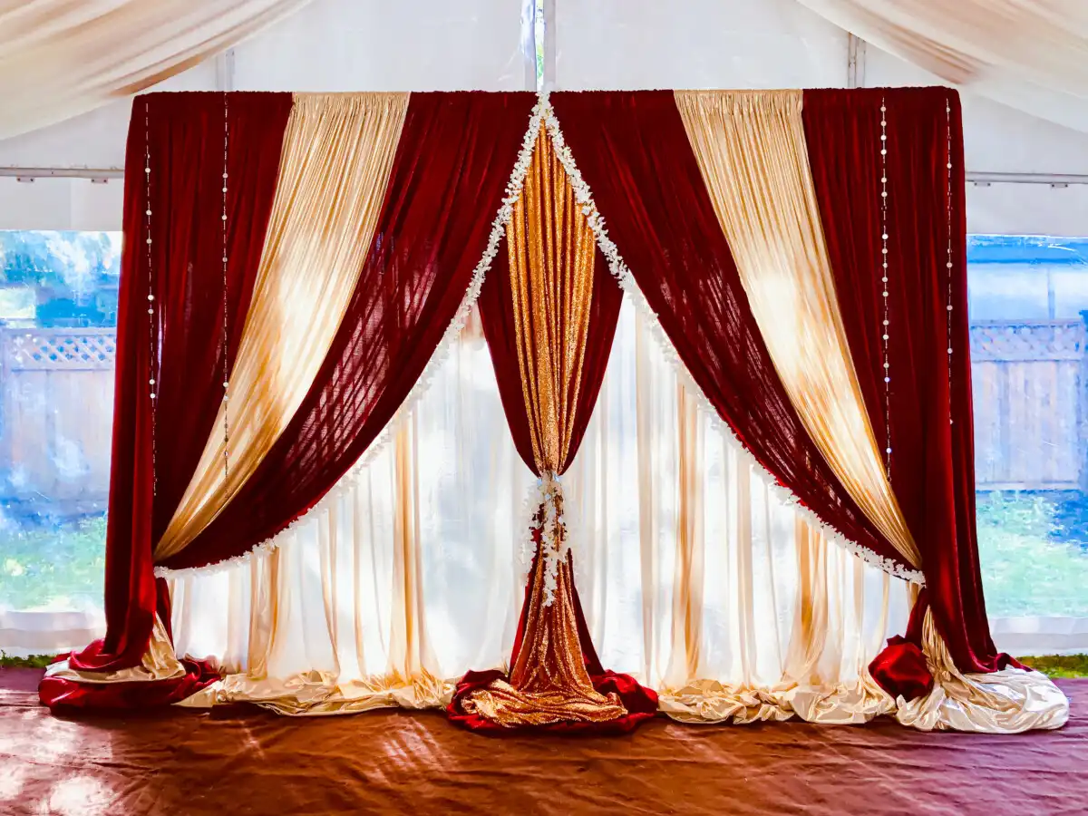 Burgundy and gold tent backdrop · Dream Decorators