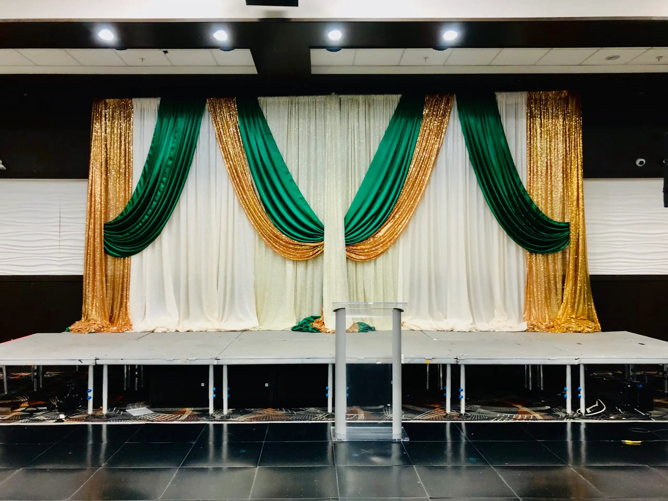 Emerald green and gold sequin stage backdrop · Dream Decorators