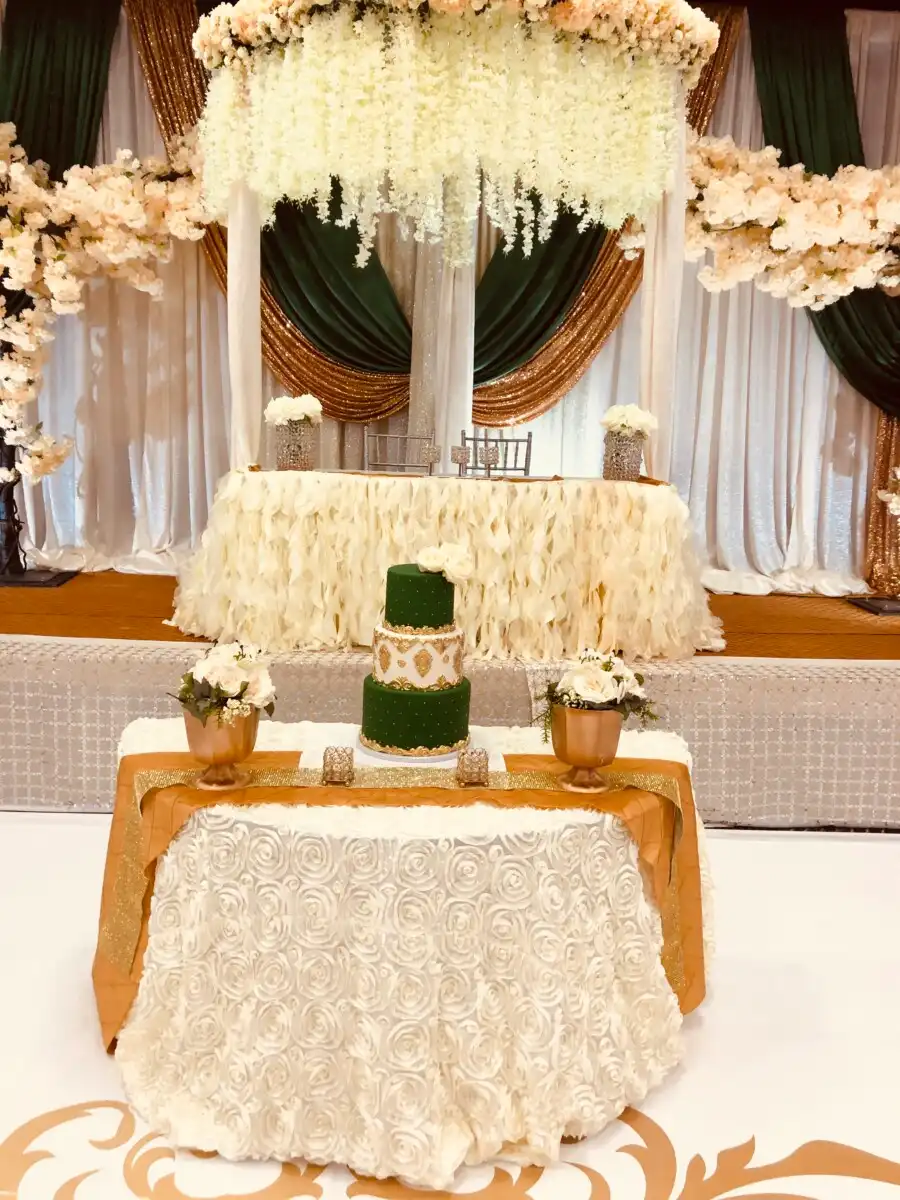 Forest green and gold reception with floral chandelier · Dream Decorators