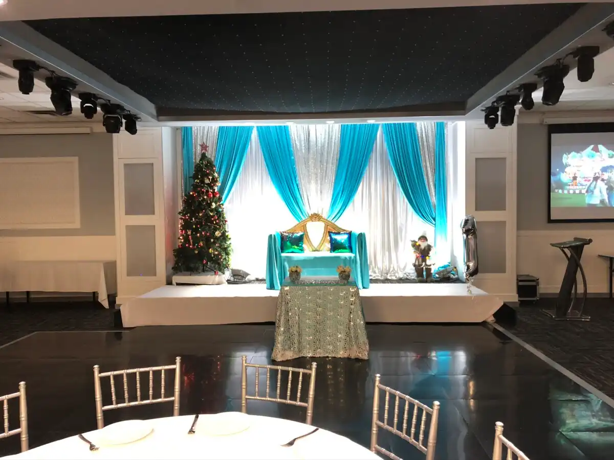 Teal and silver winter reception stage with Christmas tree · Dream Decorators