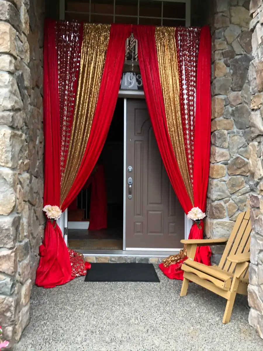 Red and gold home entrance door draping · Dream Decorators