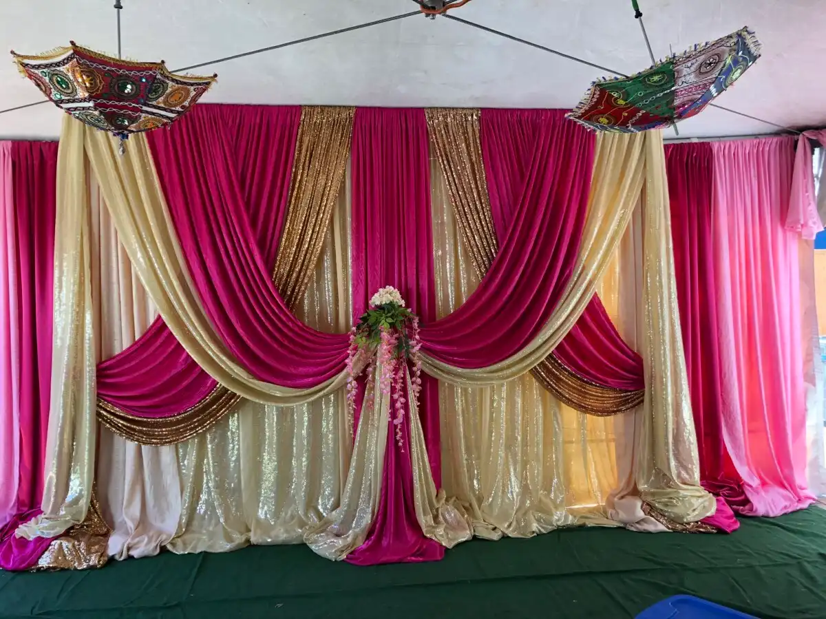 Magenta and gold backdrop with chhatri umbrellas · Dream Decorators