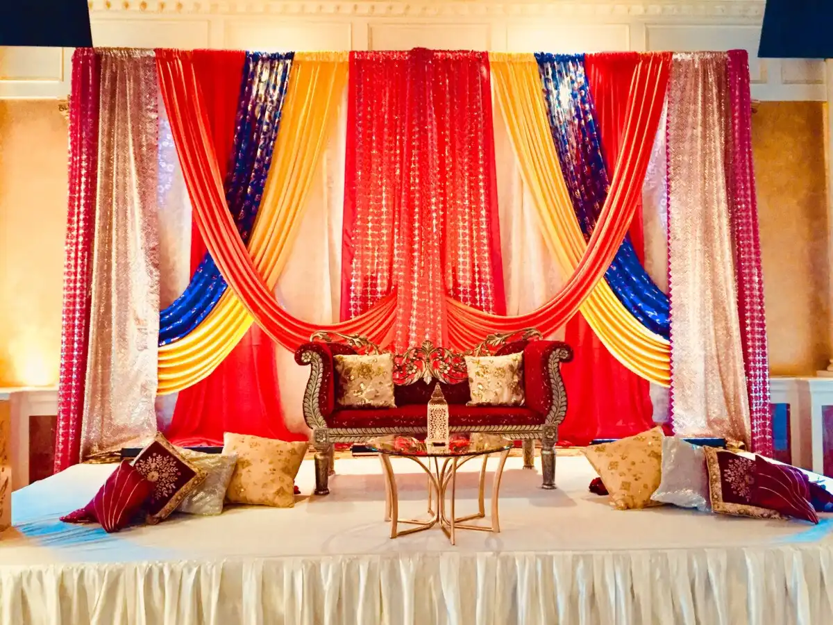 Multi-color traditional stage with floor cushions · Dream Decorators