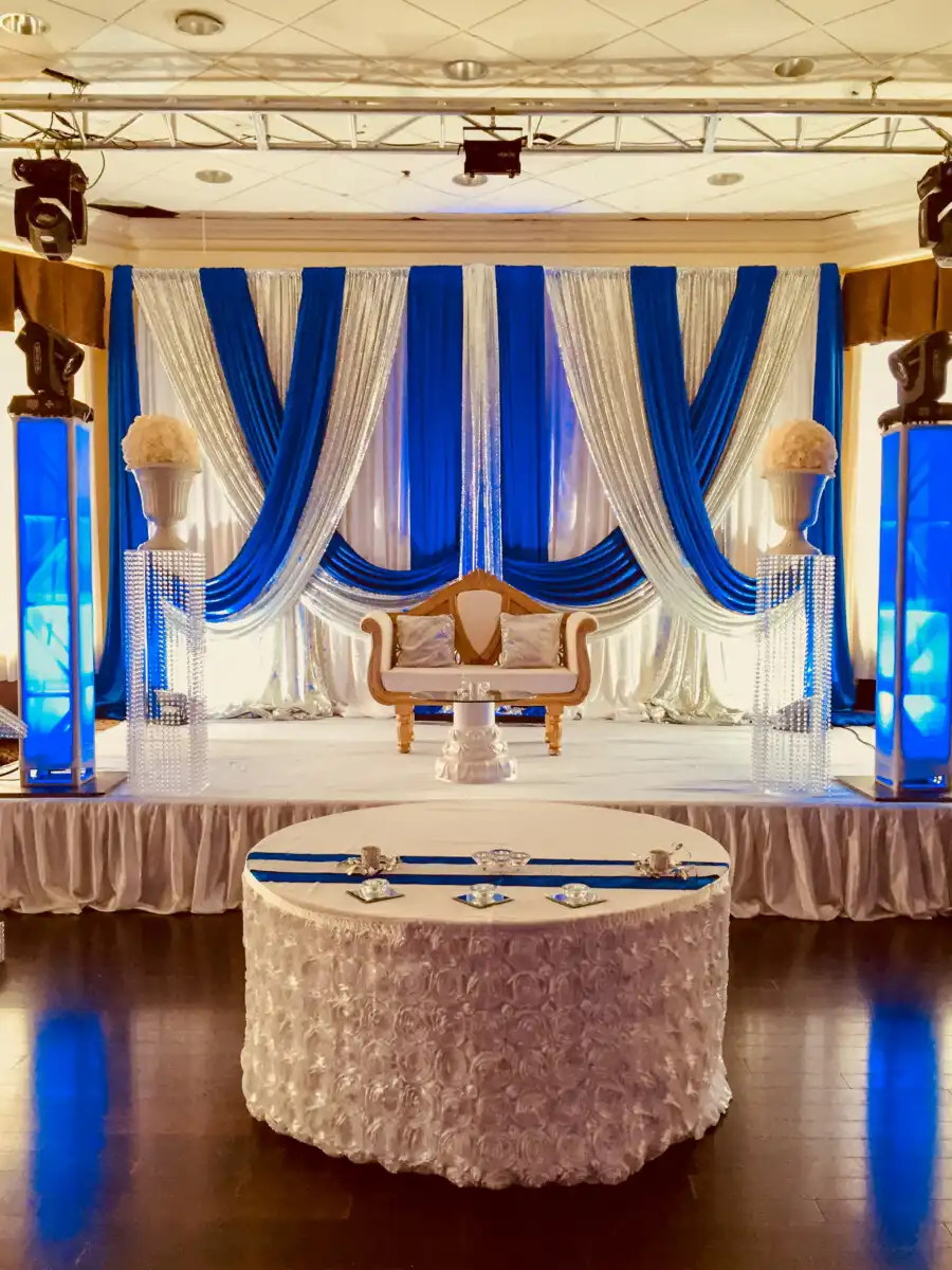 Royal blue and silver stage with crystal pillars · Dream Decorators