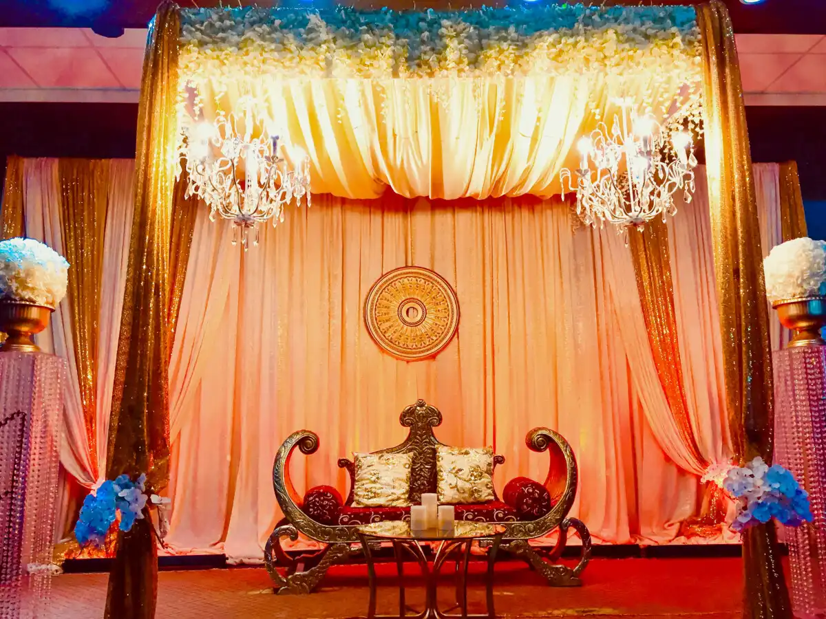 Gold and peach stage with crystal chandeliers · Dream Decorators