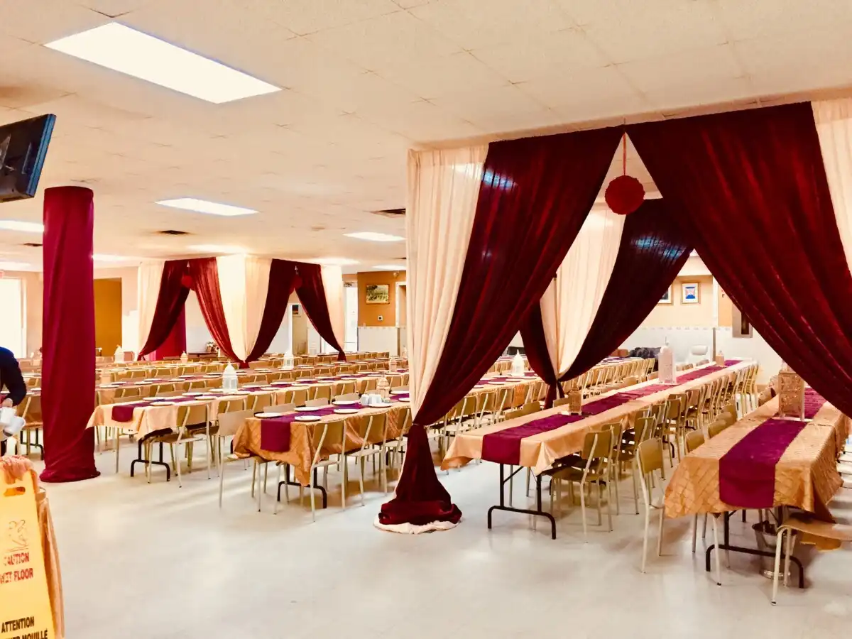 Burgundy and gold hall draping with lanterns · Dream Decorators