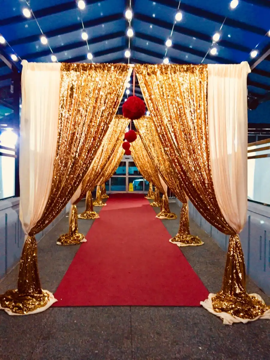 Red carpet entrance with gold sequin arches · Dream Decorators