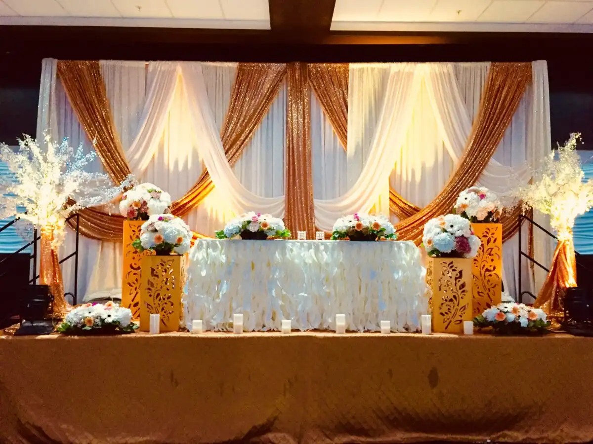 Gold and white sequin head table with lighted trees · Dream Decorators