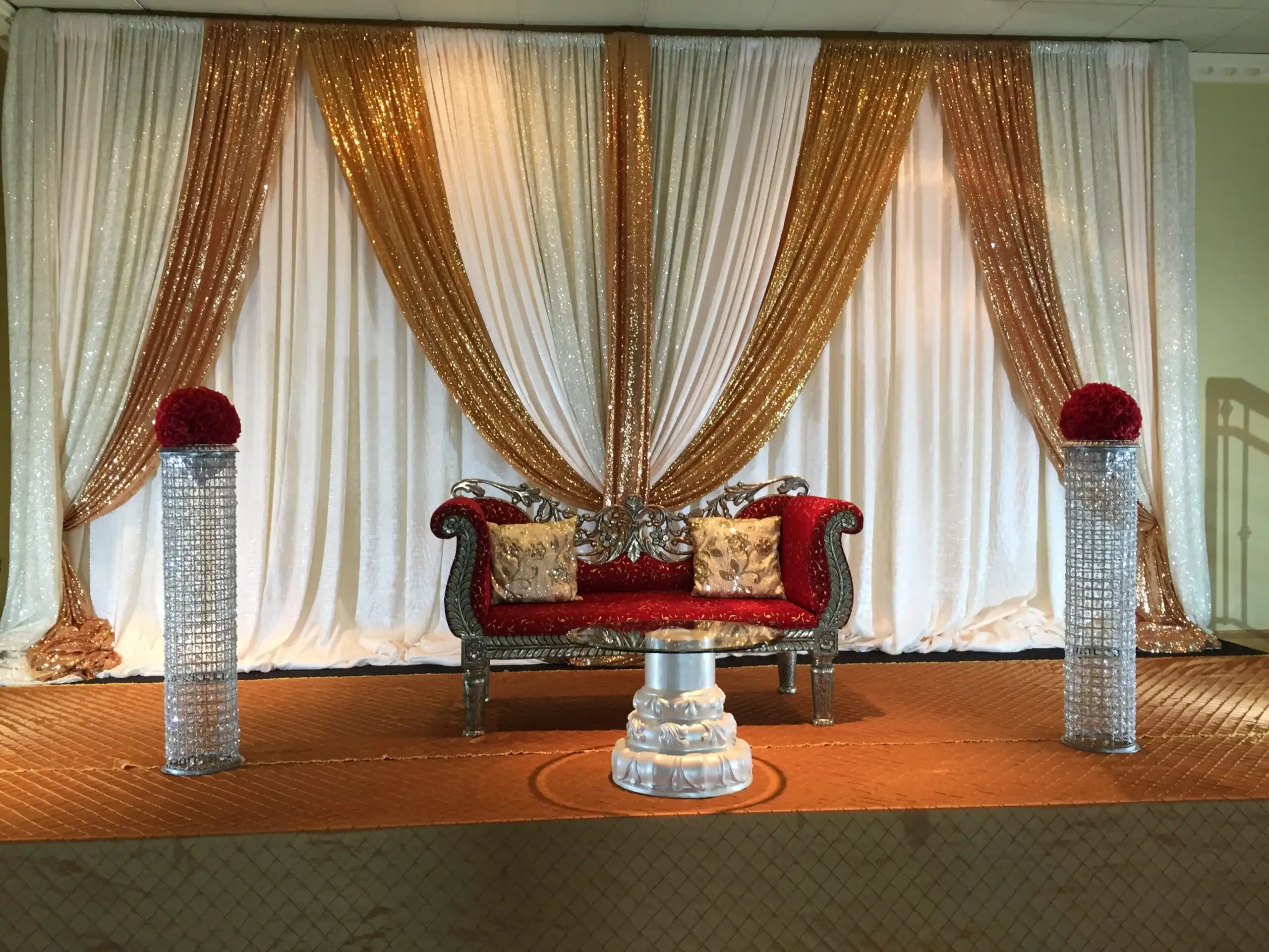 Red velvet reception stage with gold sequin backdrop · Dream Decorators