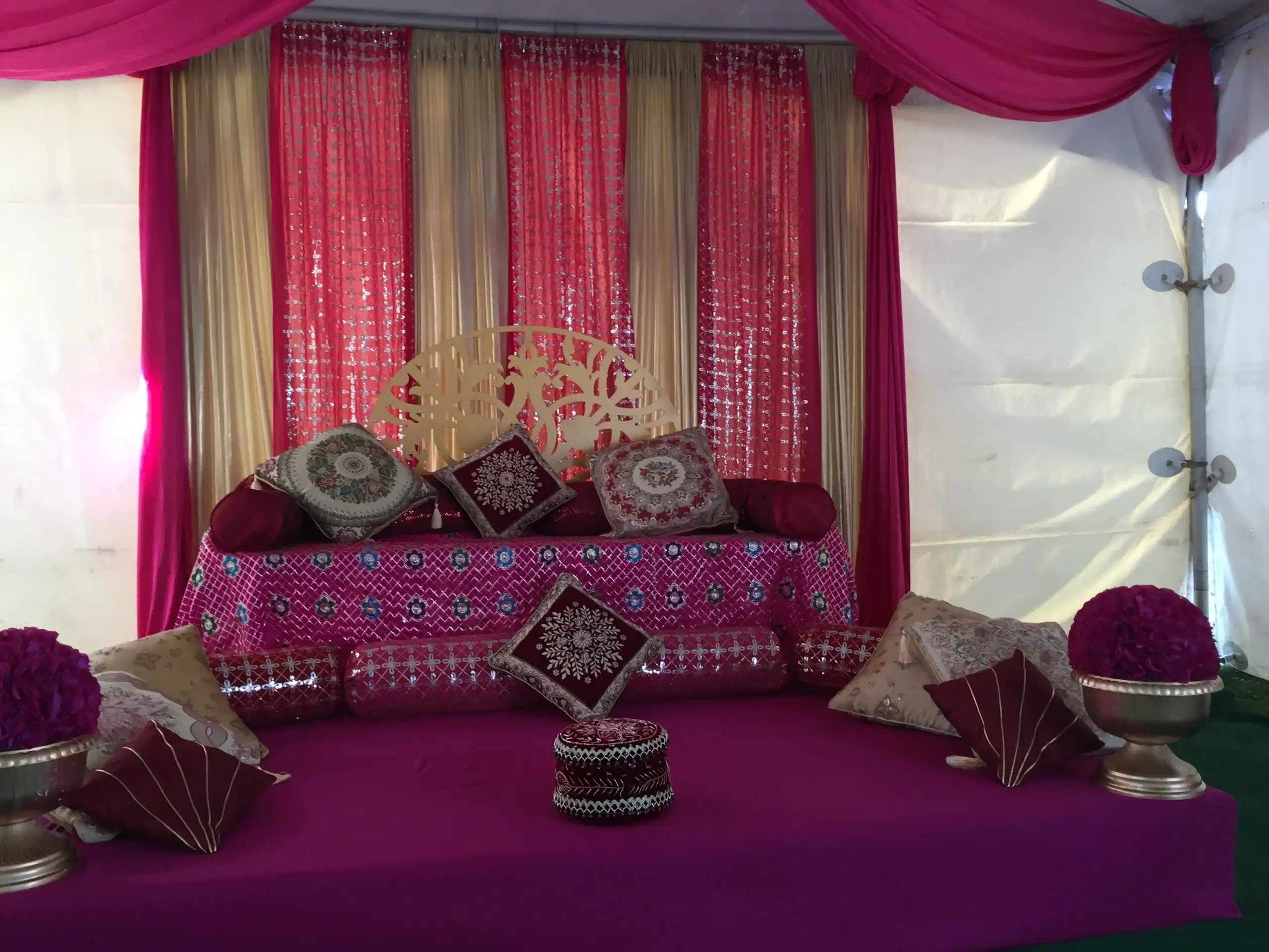 Hot pink maiyan floor seating with embroidered bolsters · Dream Decorators