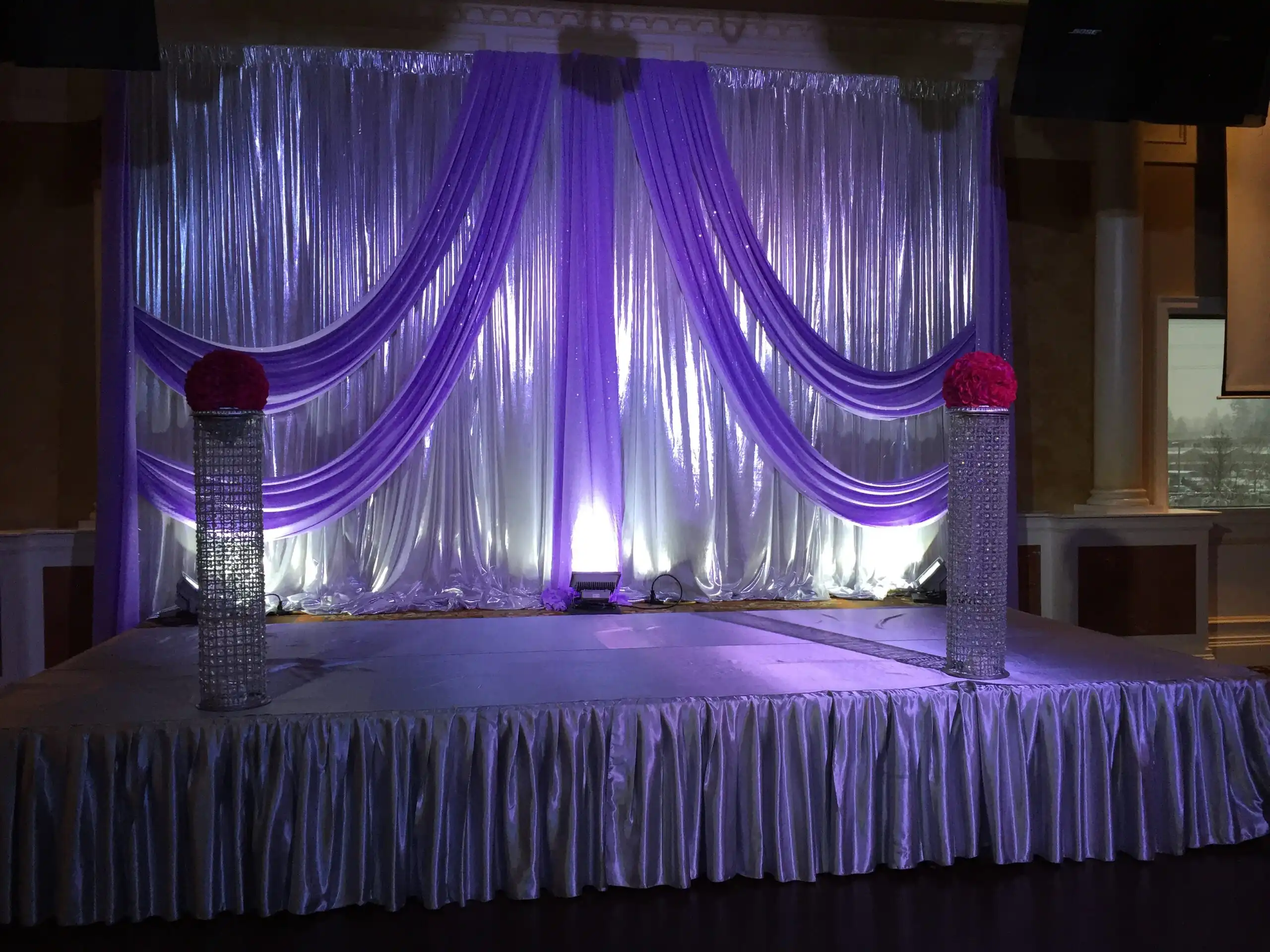 Silver and lavender reception stage with pink florals · Dream Decorators