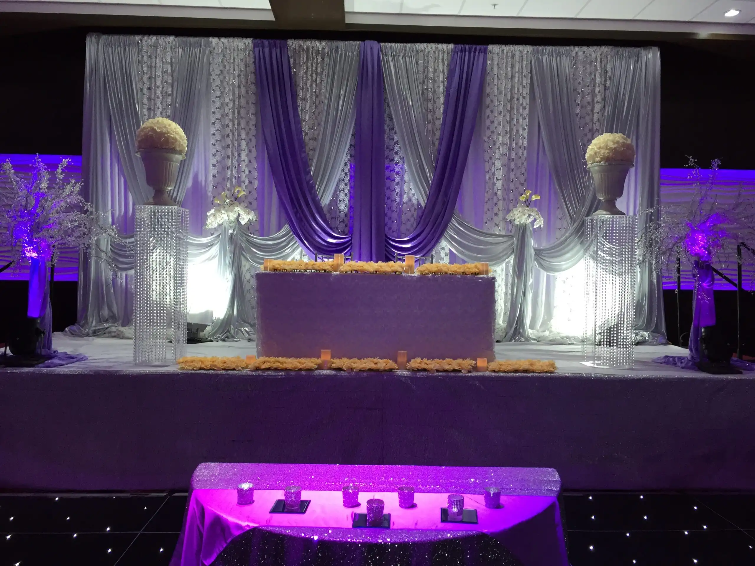 Purple and silver reception stage with crystal pillars · Dream Decorators Surrey