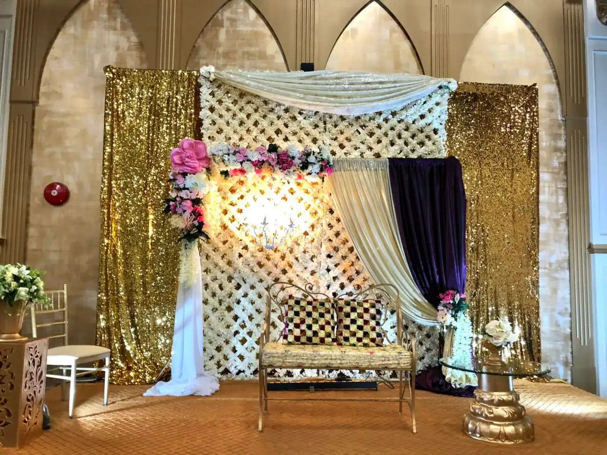 Gold sequin reception stage with heart light backdrop · Dream Decorators