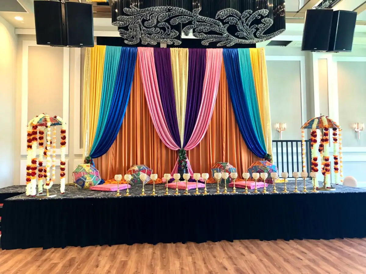 Multi-color sangeet stage with Rajasthani umbrellas · Dream Decorators