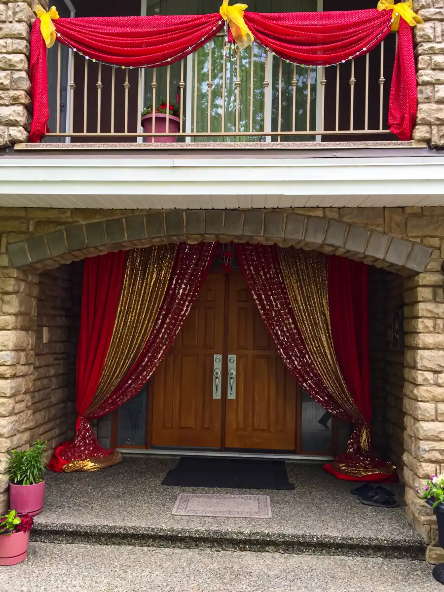 Red and gold home entrance and balcony décor · Dream Decorators Surrey