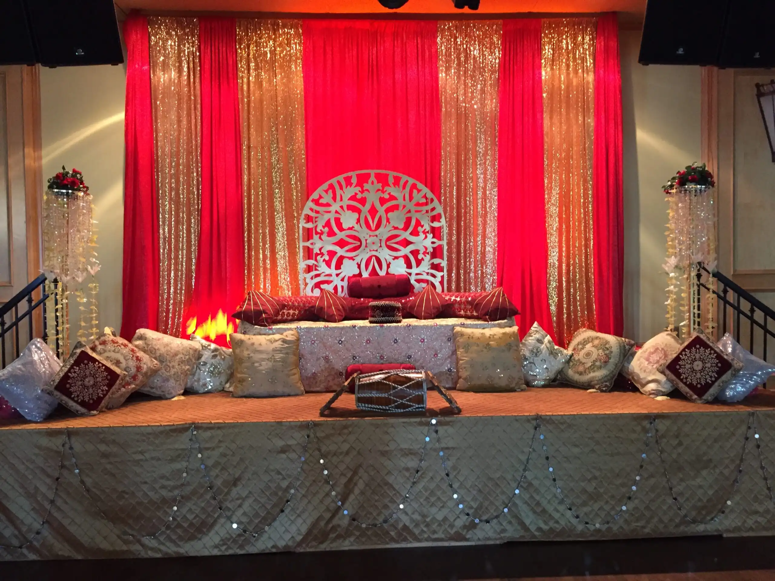 Red and gold sangeet stage with dhol drum · Dream Decorators