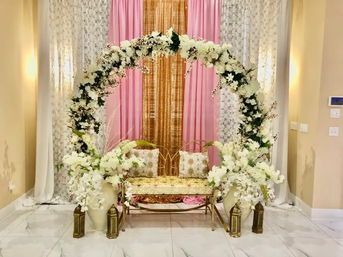 Pink and gold floral moongate stage with gold bench · Dream Decorators