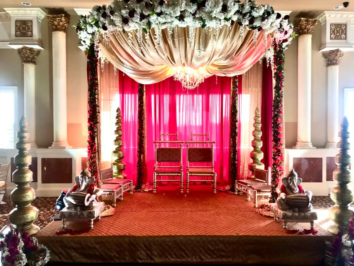 Red and gold mandap with floral canopy · Dream Decorators