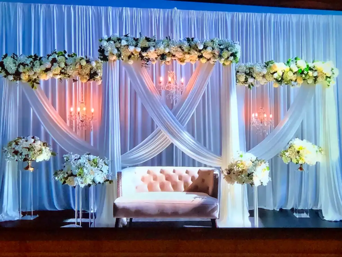 White and blush stage with crystal chandeliers · Dream Decorators