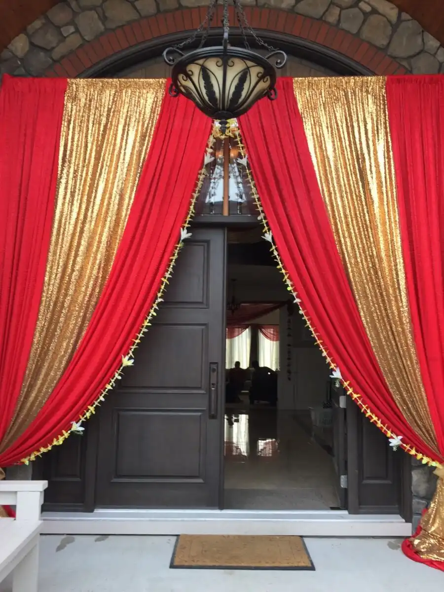 Red and gold home entrance with chandelier · Dream Decorators Surrey
