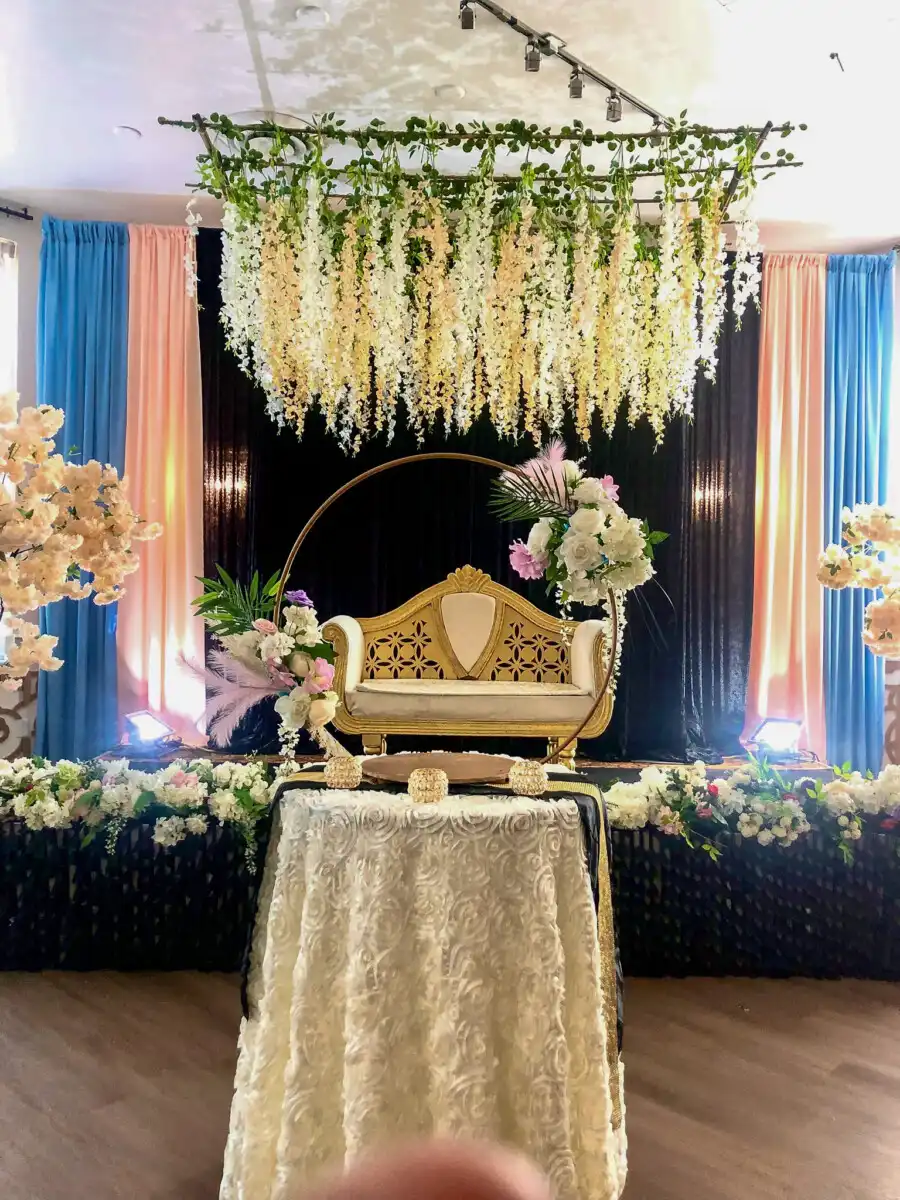 Gold hoop stage with cascading wisteria · Dream Decorators