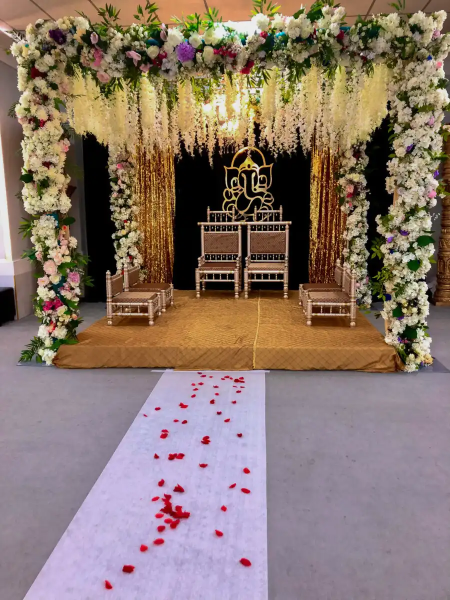 Floral mandap with golden Ganesha backdrop · Dream Decorators