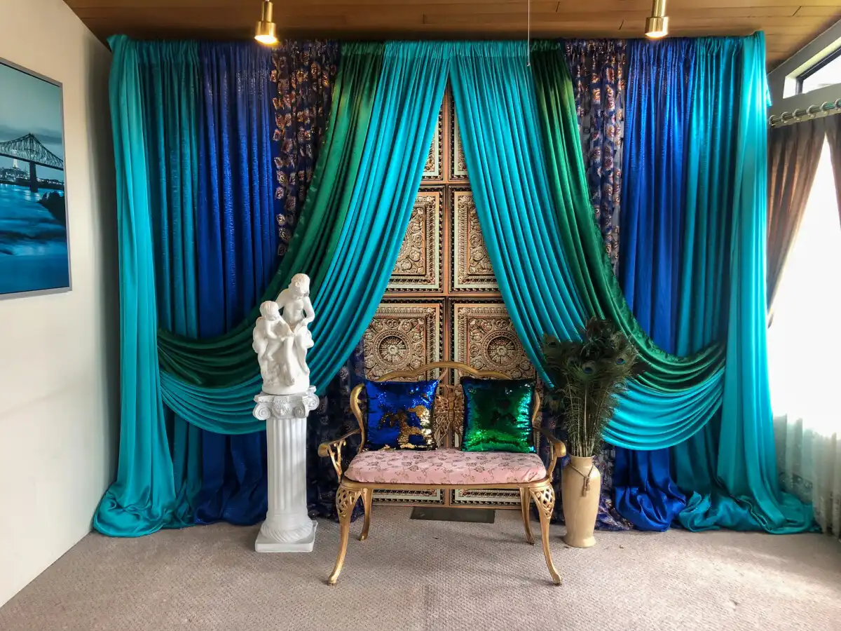 Peacock-themed backdrop with gold settee · Dream Decorators