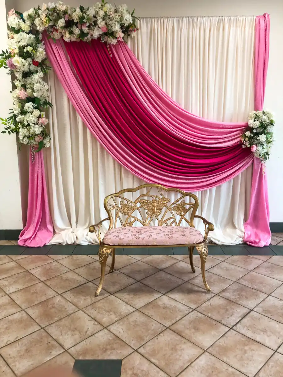 Pink and magenta backdrop with gold butterfly bench · Dream Decorators
