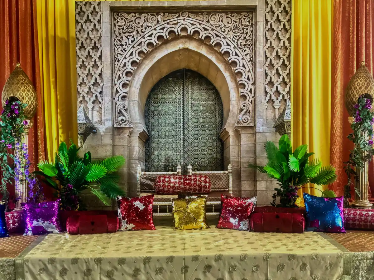 Moroccan arch sangeet seating area · Dream Decorators